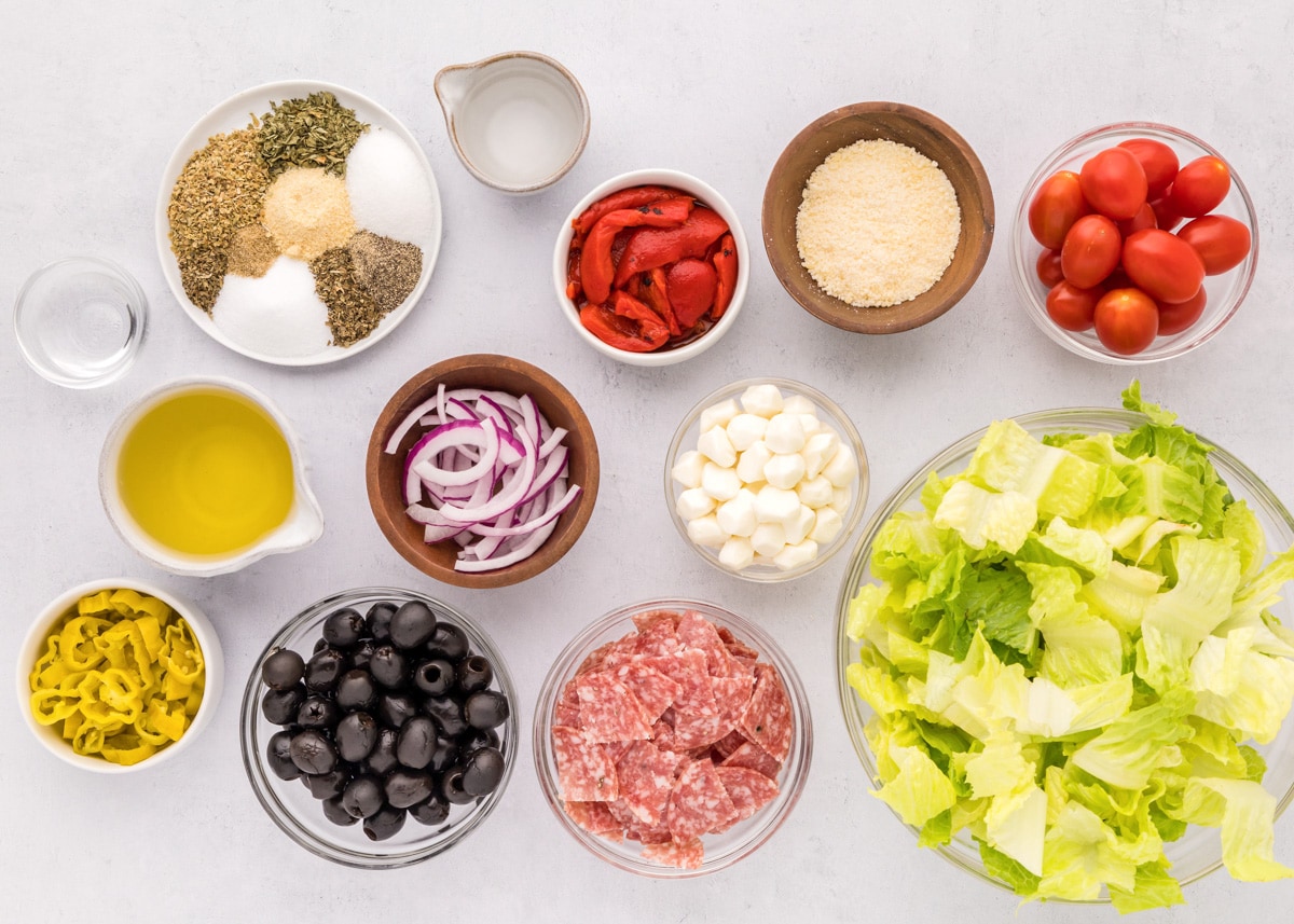 Ingredients for antipasto salad in separate bowls.