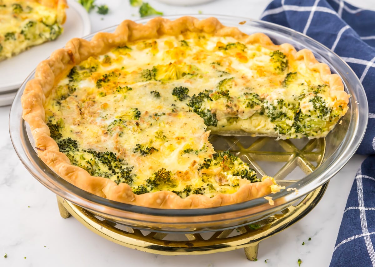 A baked quiche filled with broccoli and cheese.