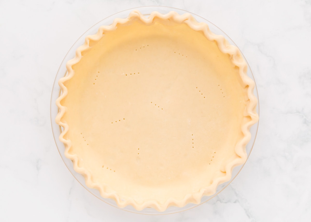 A prepped pie crust in a pie plate.
