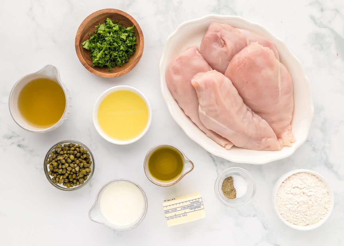 Ingredients for chicken piccata set out on a kitchen counter.