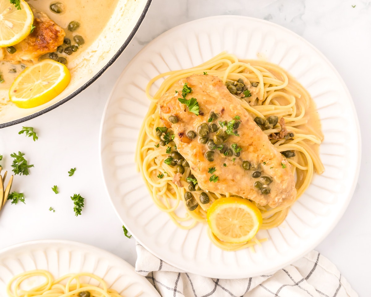 Best chicken piccata recipe served over a bed of pasta.