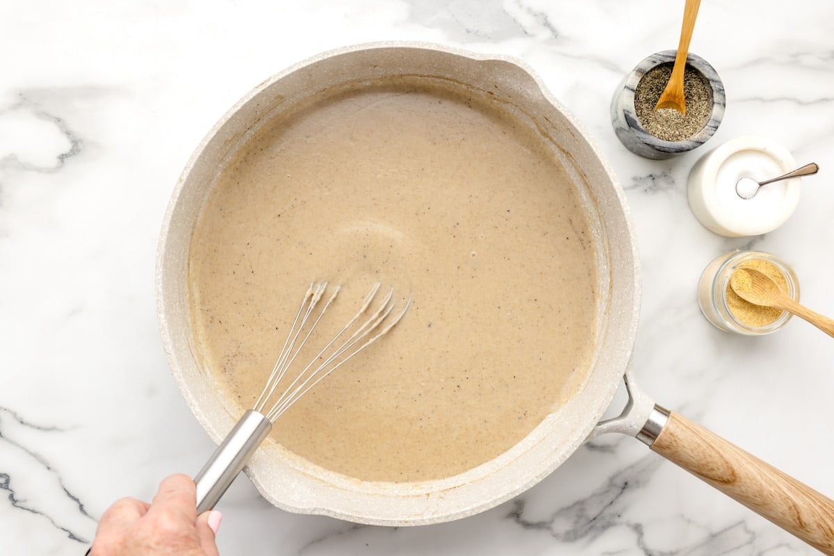 Thickened gravy in a pan on a counter.