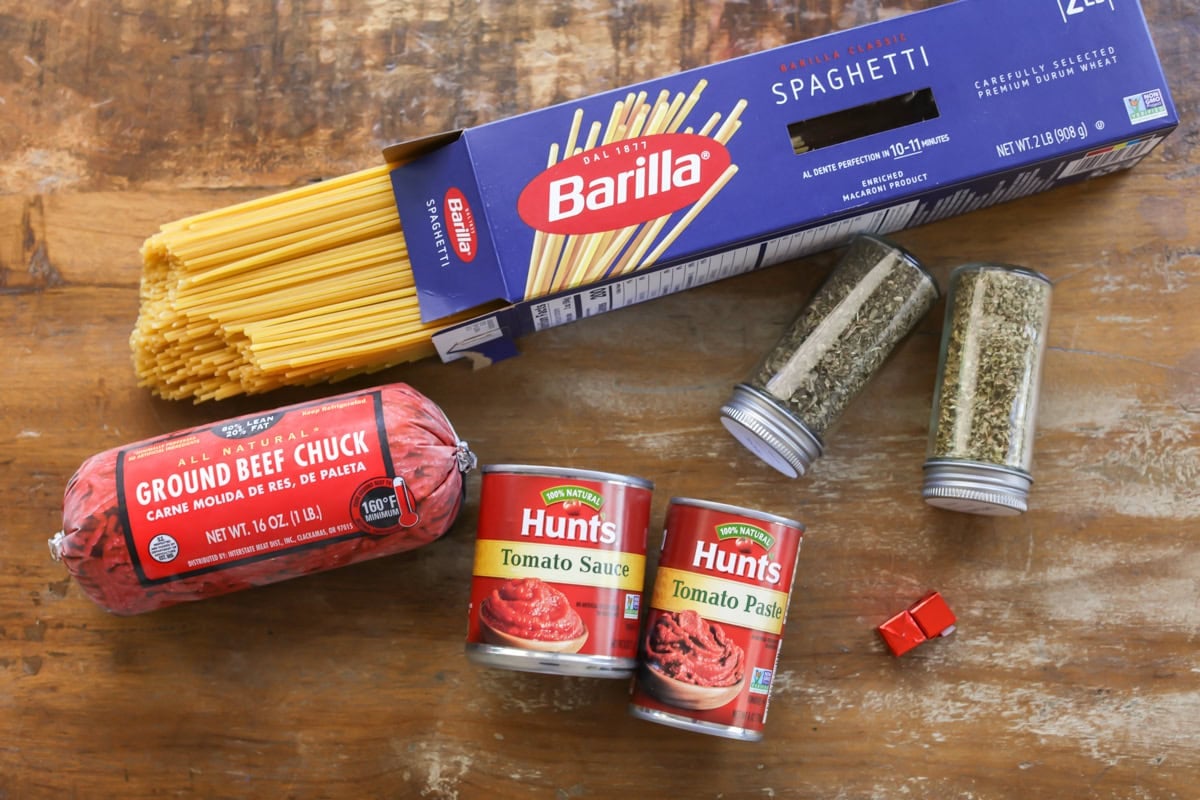 Spaghetti ingredients on wood table.