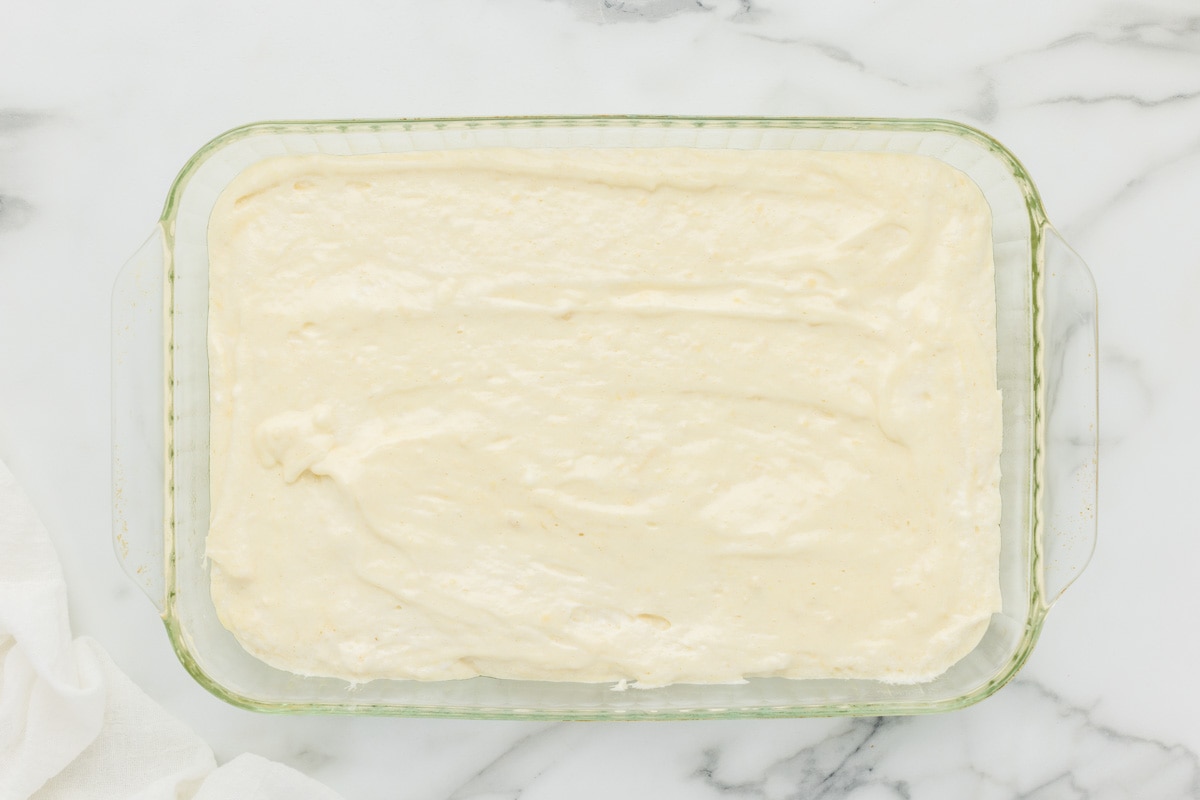 Sponge cake batter spread in a baking dish.