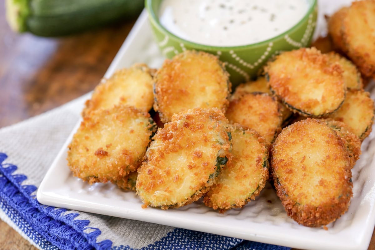 Fried zucchini on white platter with ranch recipe.