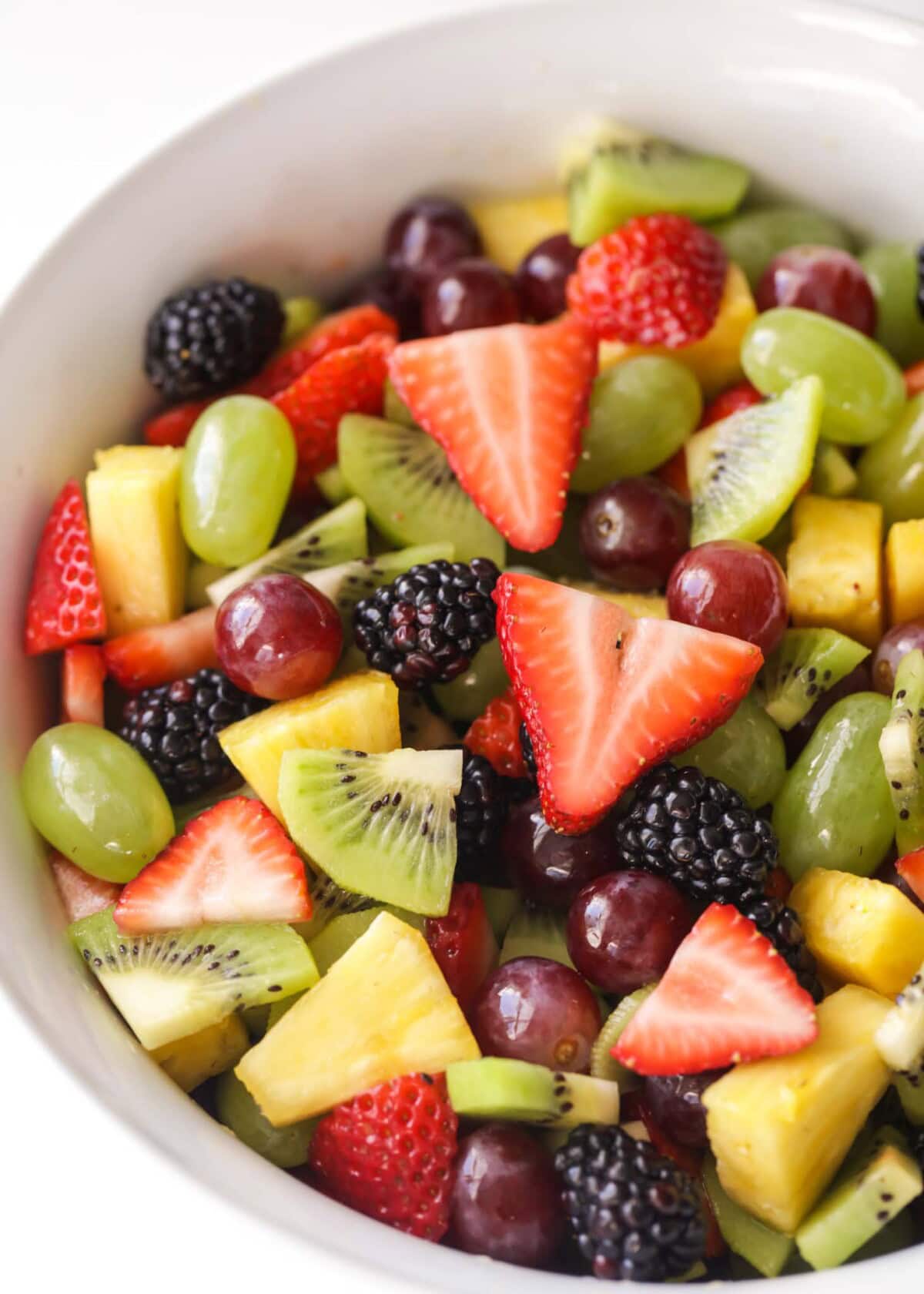 Fruit salad recipe served in a white bowl.