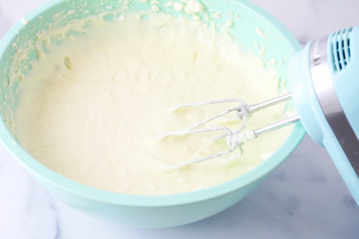 Homemade whipped cream in a mixing bowl.