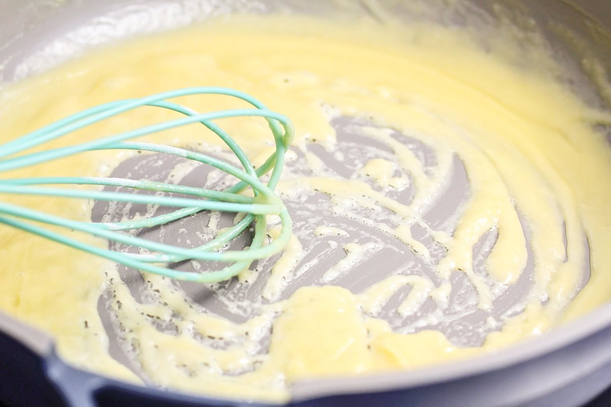 Whisking a roux in a pan.