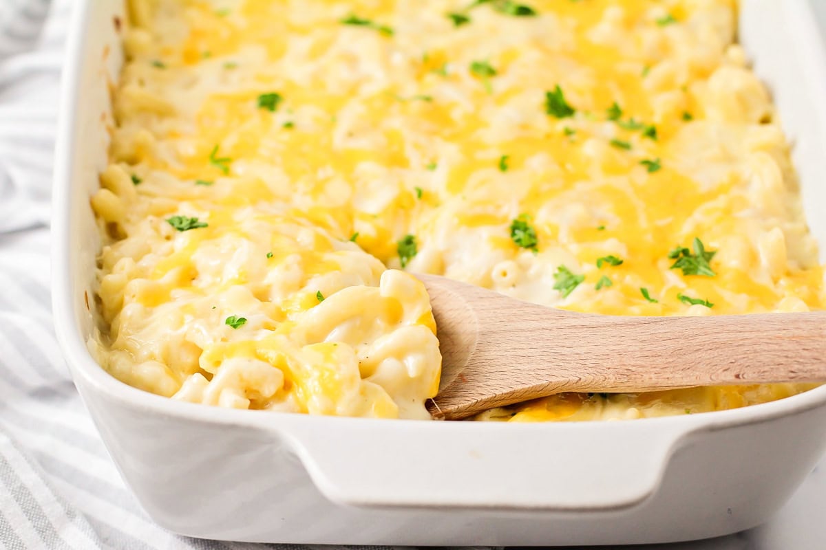 Scooping Chick Fil A Mac and cheese form a baking dish.