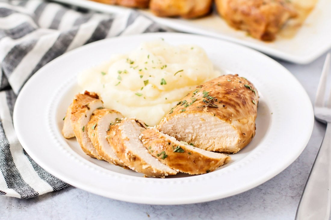 Our family-favorite chicken marinade recipe sliced on late with mashed potatoes.