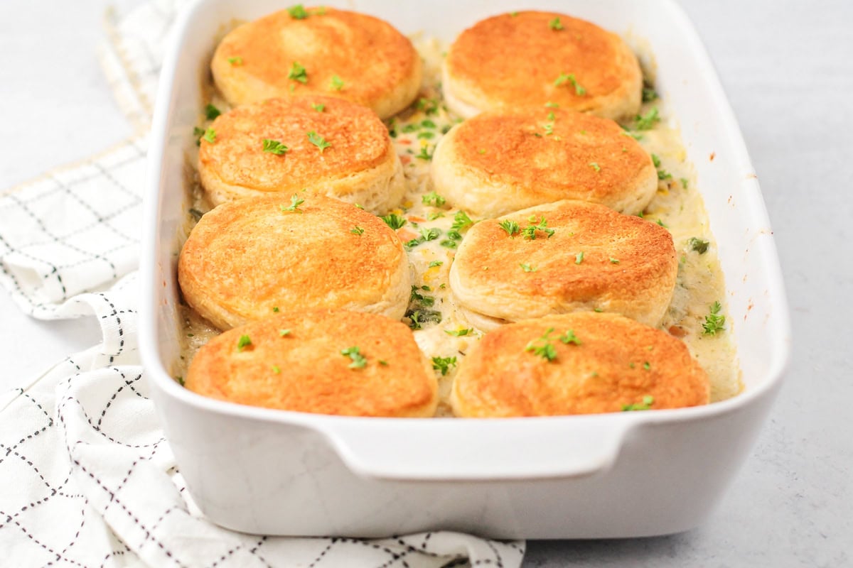 Chicken pot pie casserole topped with golden brown biscuits.