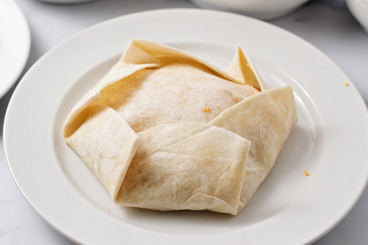 Folded up tortillas to make crunch wrap supreme.