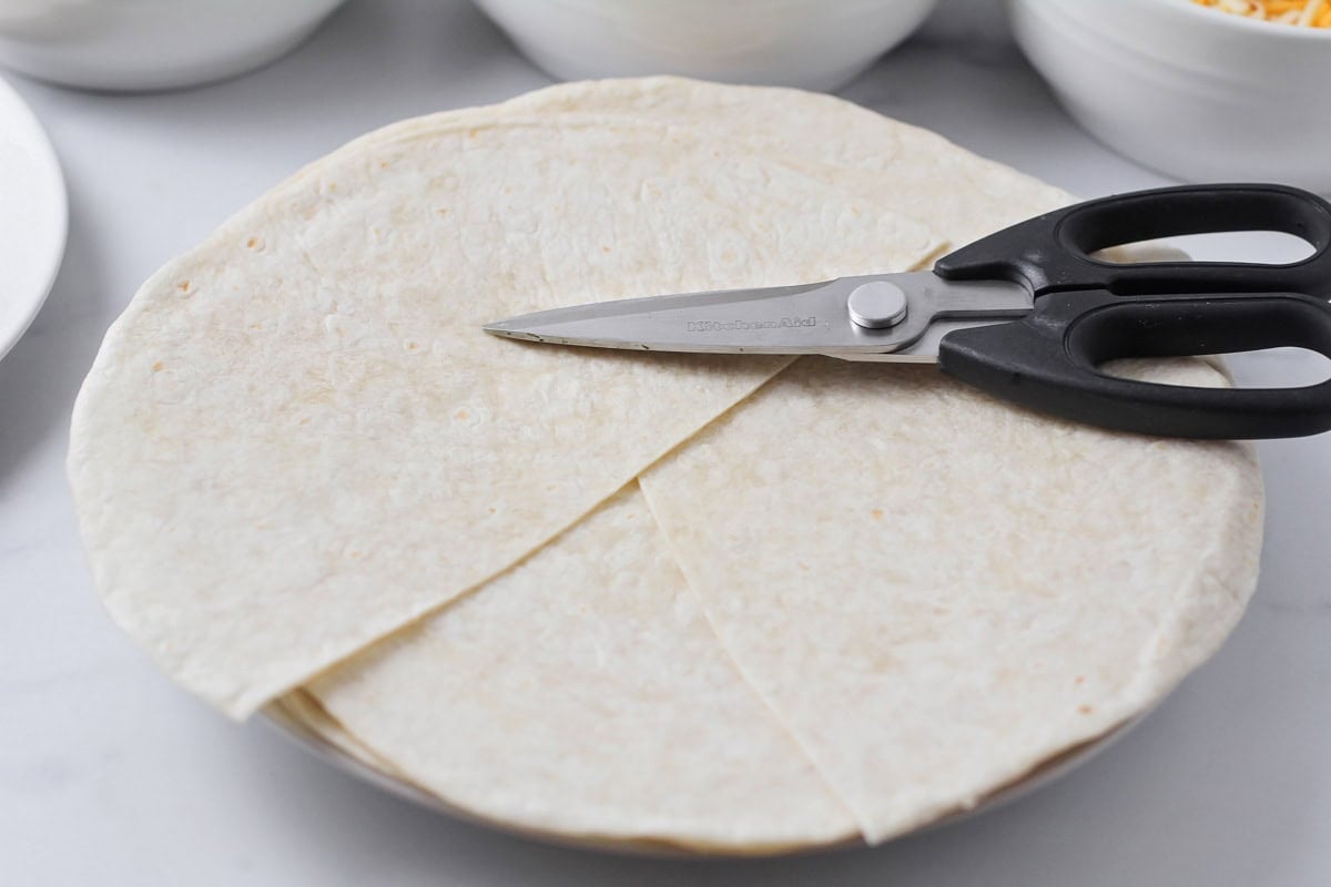 Cutting tortillas to make crunchwrap supreme.