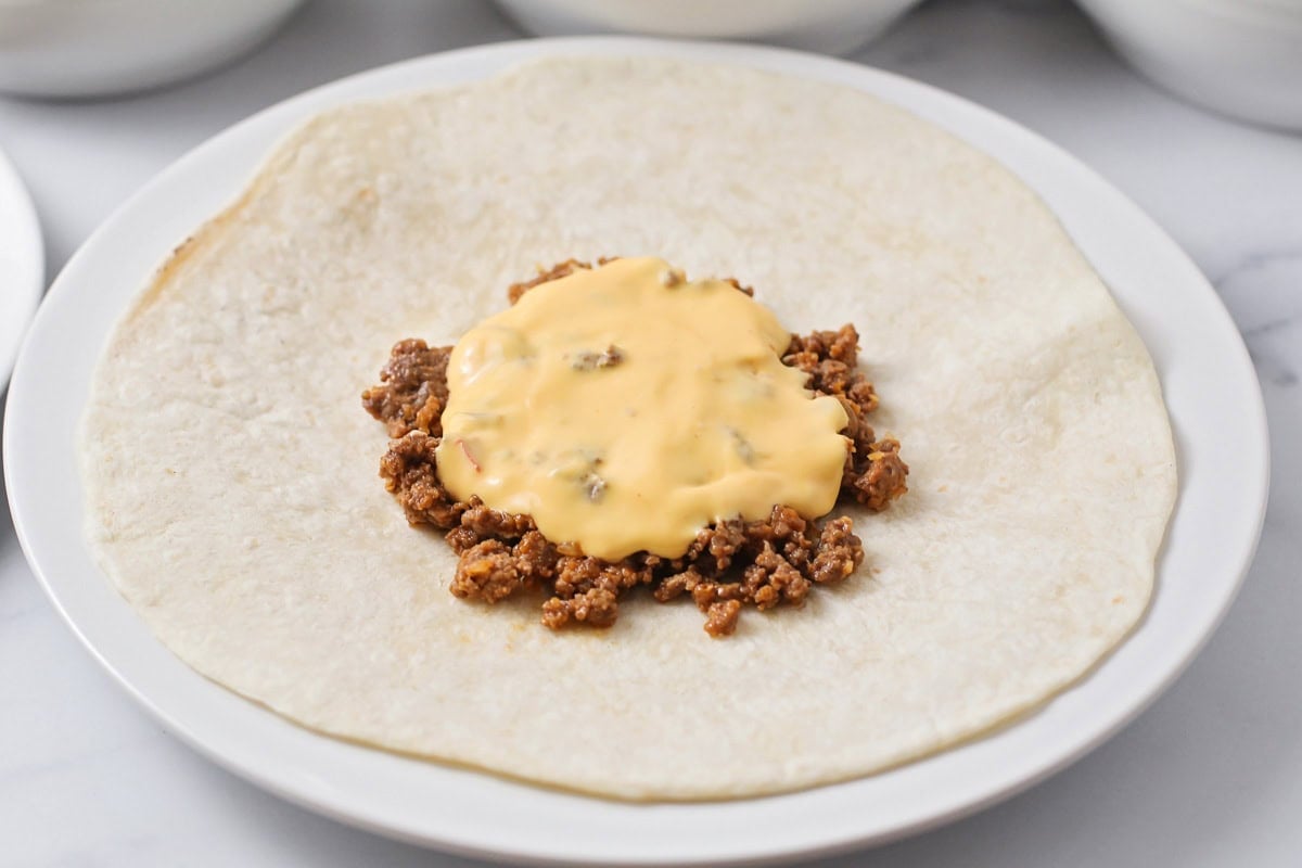 Hamburger and cheese on tortillas.