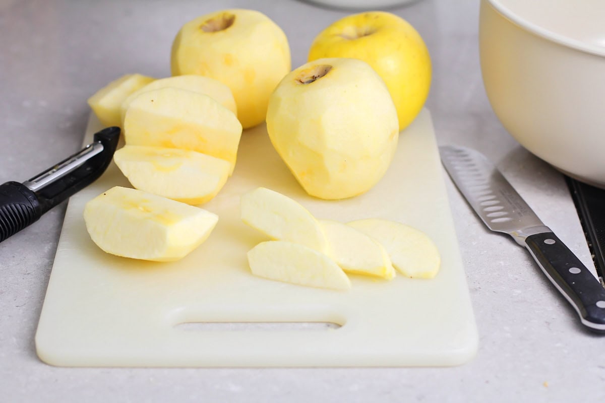 Prepping apples on a cutting board.