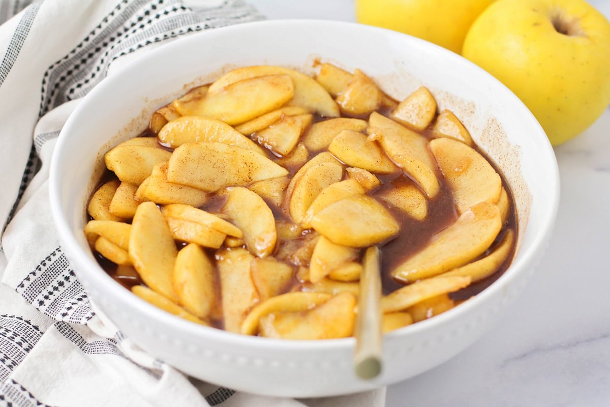 A white bowl of fried apples.