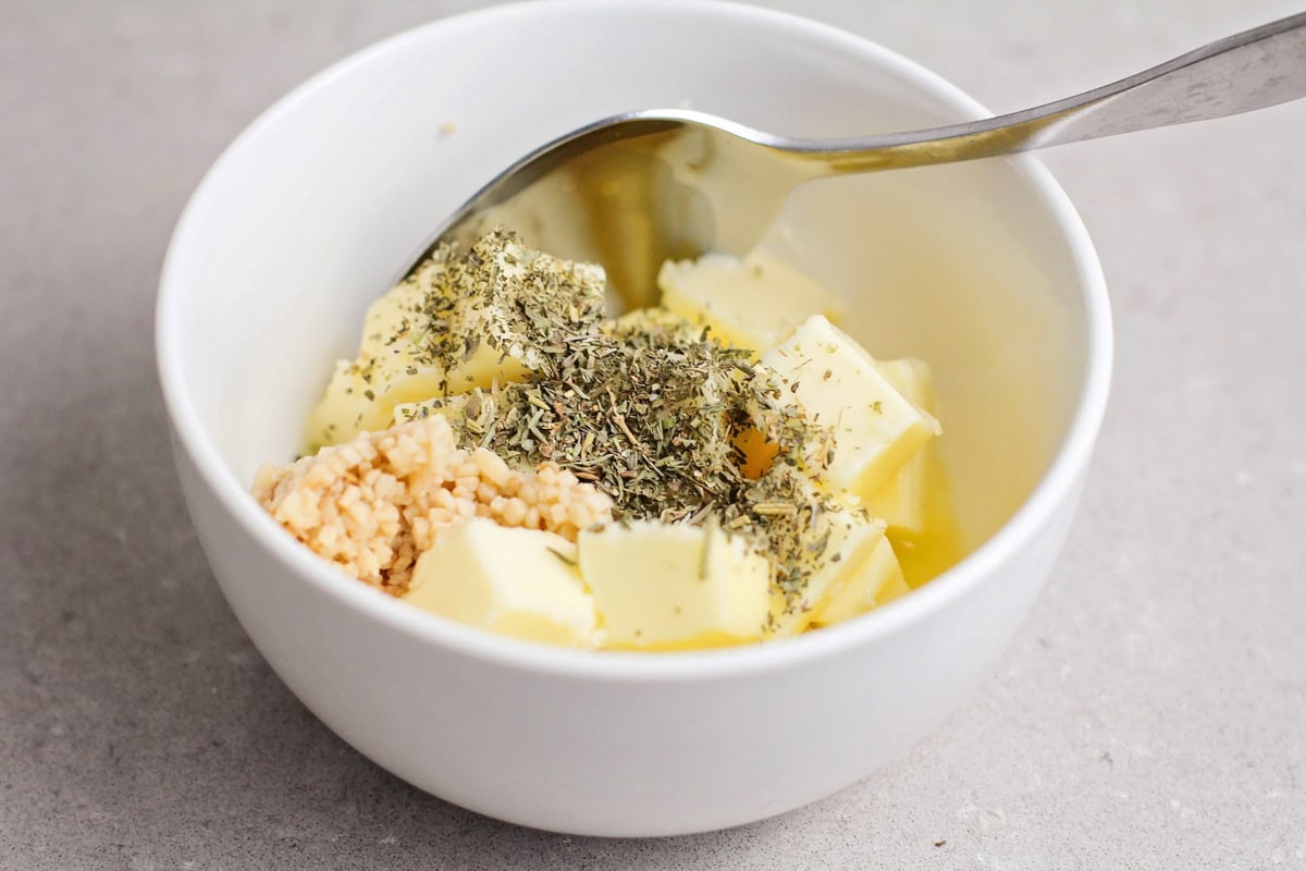 Butter and seasonings in a white bowl.