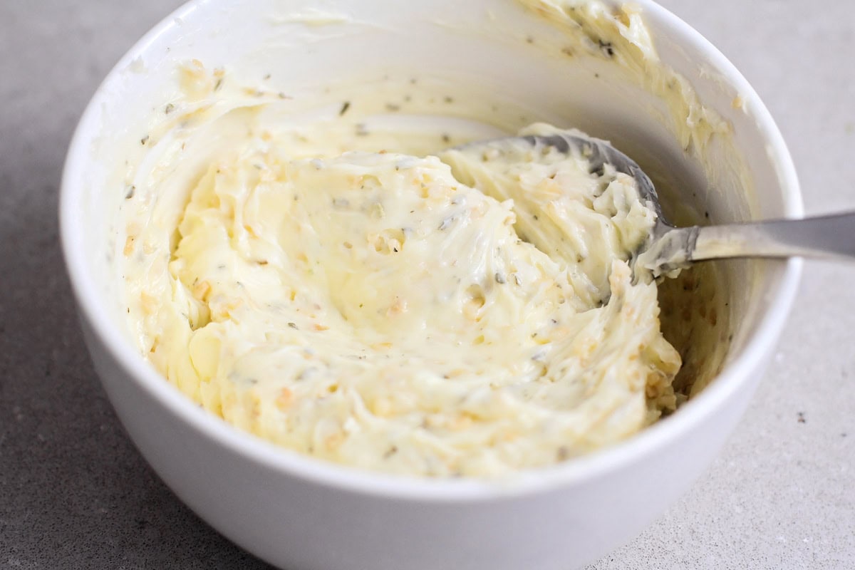 A garlic butter mixture in a white bowl.