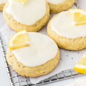 Multiple lemon poppy seed cookies on a wire cooling rack.