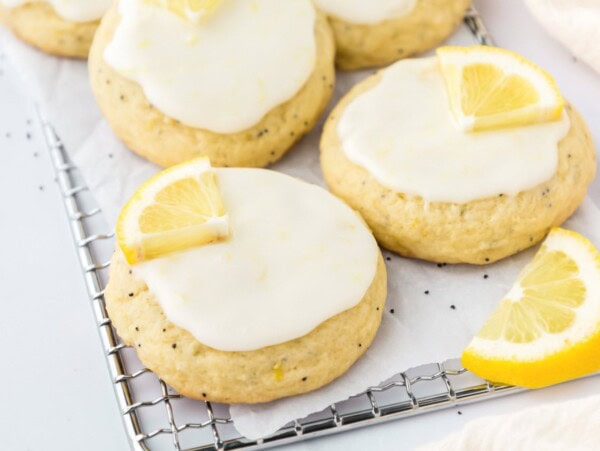 Multiple lemon poppy seed cookies on a wire cooling rack.