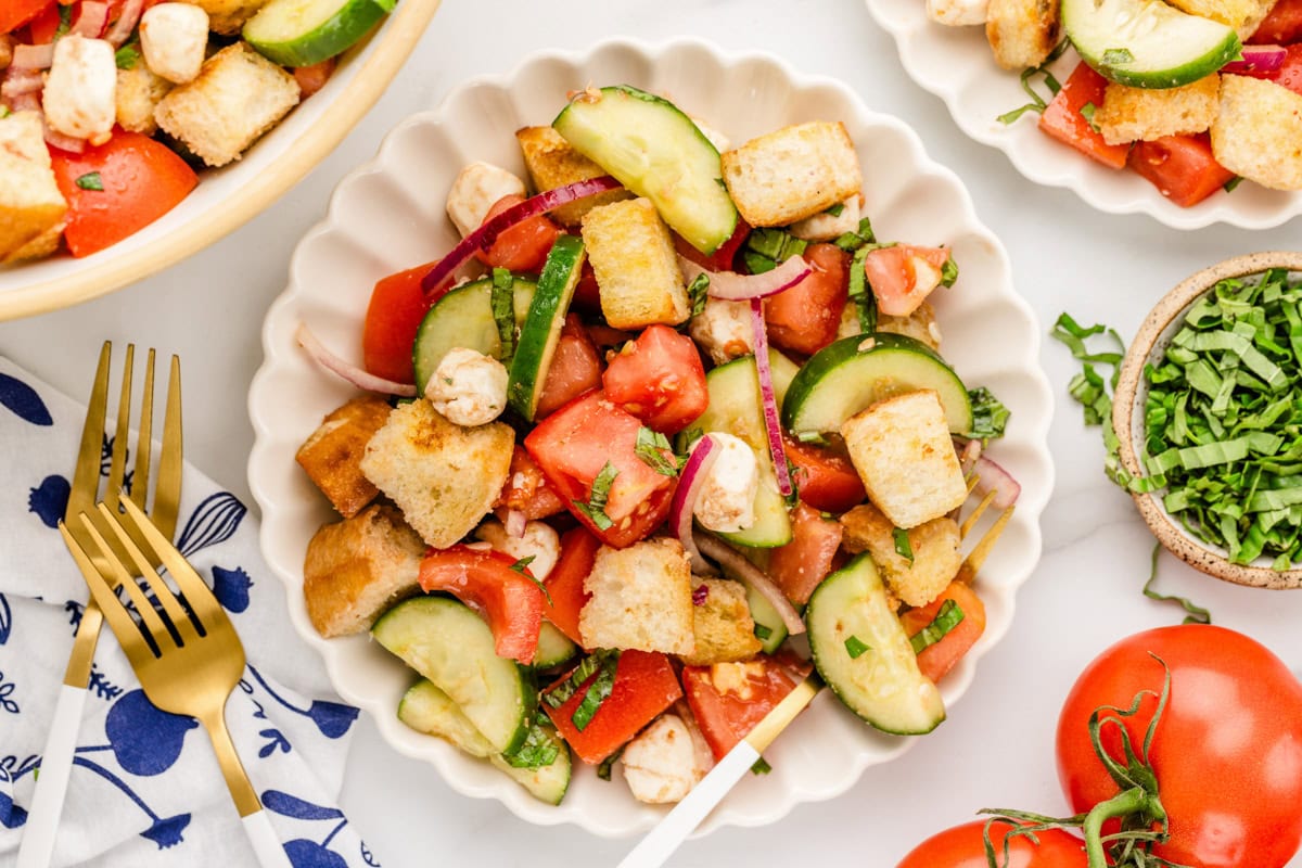 A plate of panzanella salad on a counter.