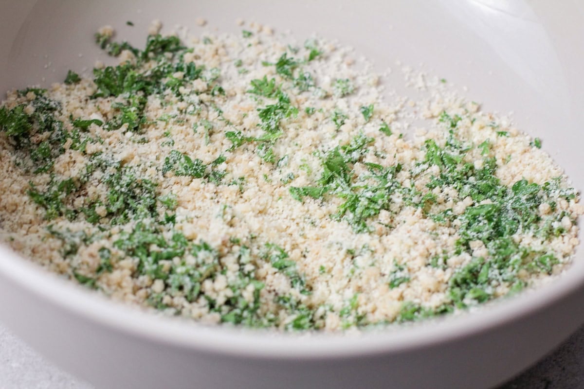 Combining breadcrumbs and herbs.