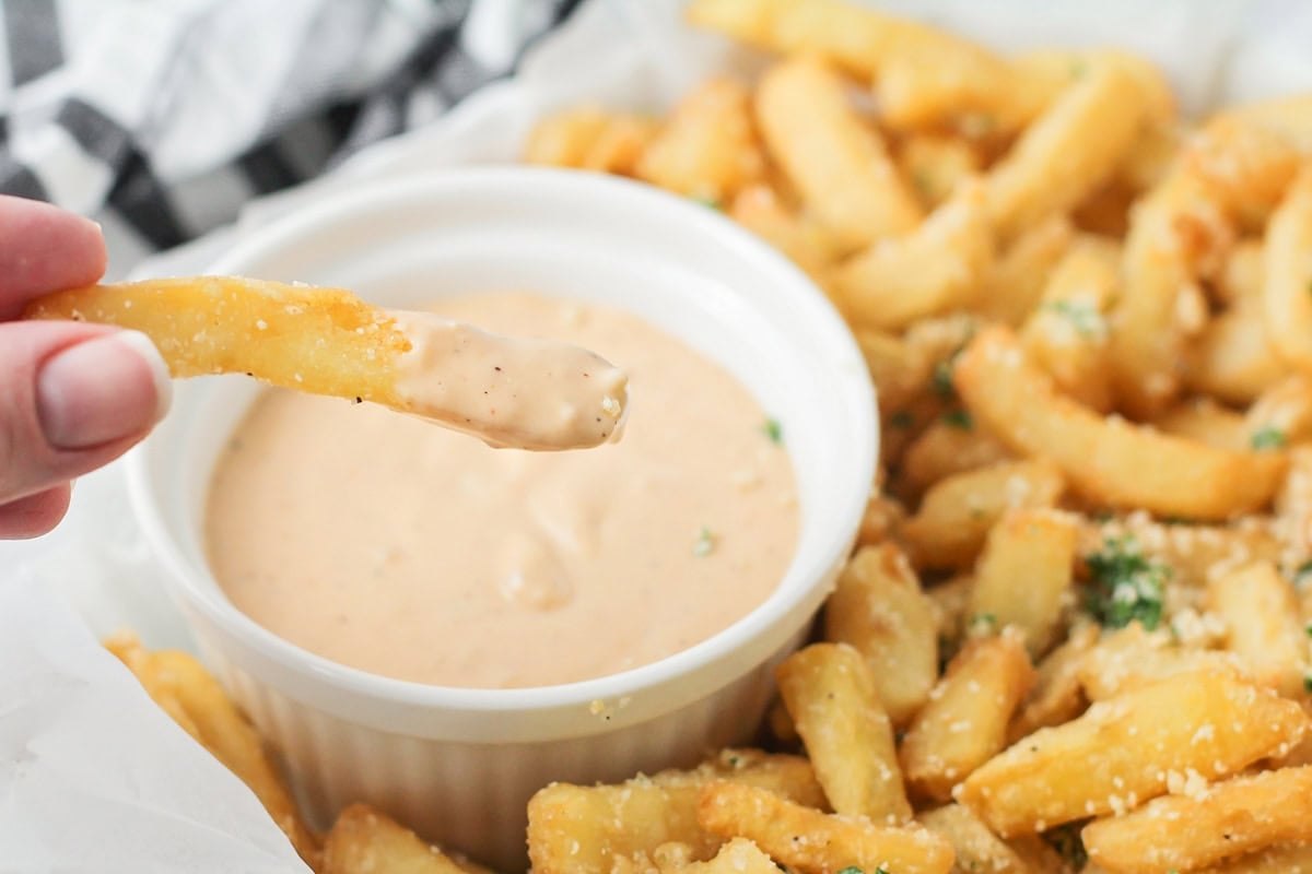 Dipping pommes frites into remoulade.