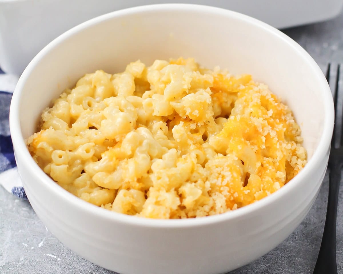 A white bowl of velveeta mac and cheese.