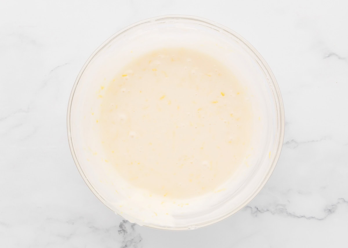 Lemon poppy seed cookie glaze in glass bowl.