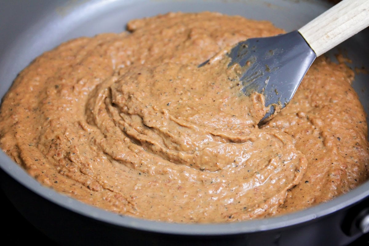 Bean mixture for pupusas in skillet.