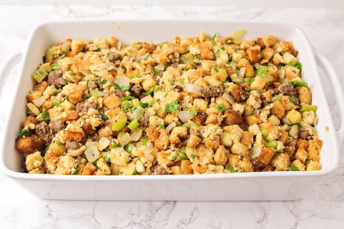 Sausage stuffing recipe in casserole dish ready to be baked.