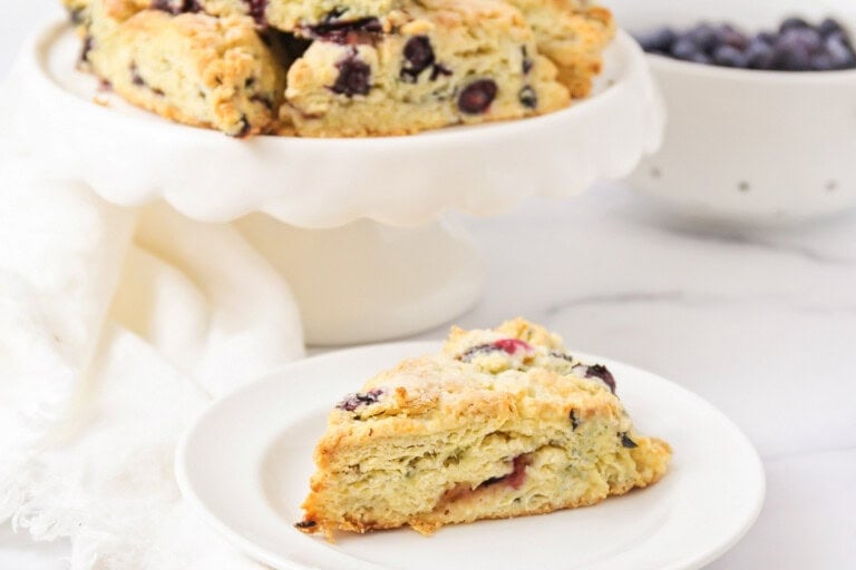 Our easy scone recipe filled with blueberries on a white plate.