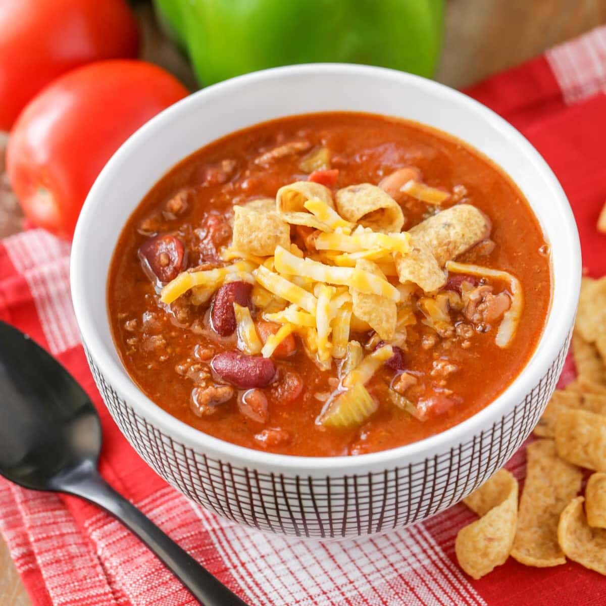 Copycat wendy's chili recipe in white bowl with black spoon.