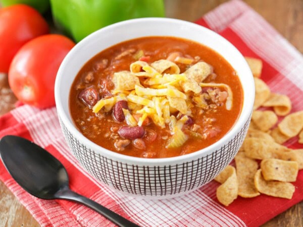 Copycat Wendy's chili recipe served in white bowl with cheese on top.