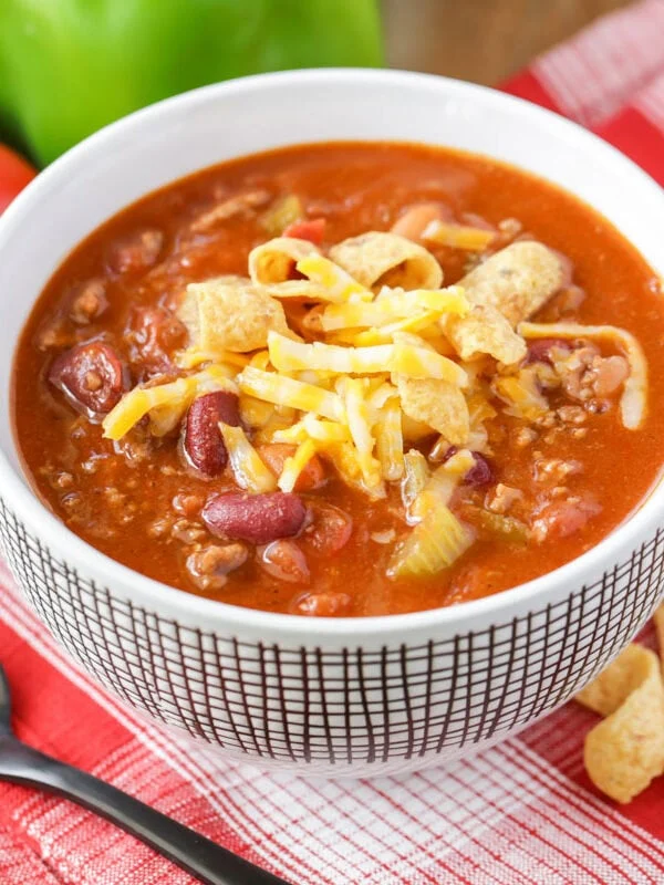 Copycat Wendy's chili recipe served in white bowl with cheese on top.