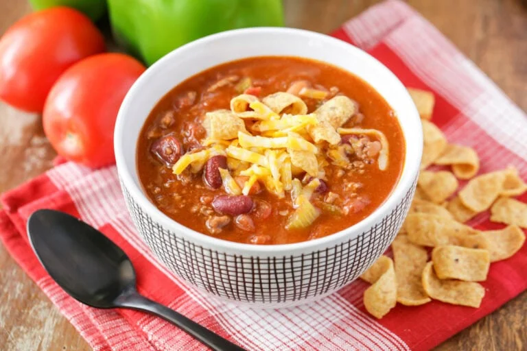 Copycat Wendy's chili recipe served in white bowl with cheese on top.