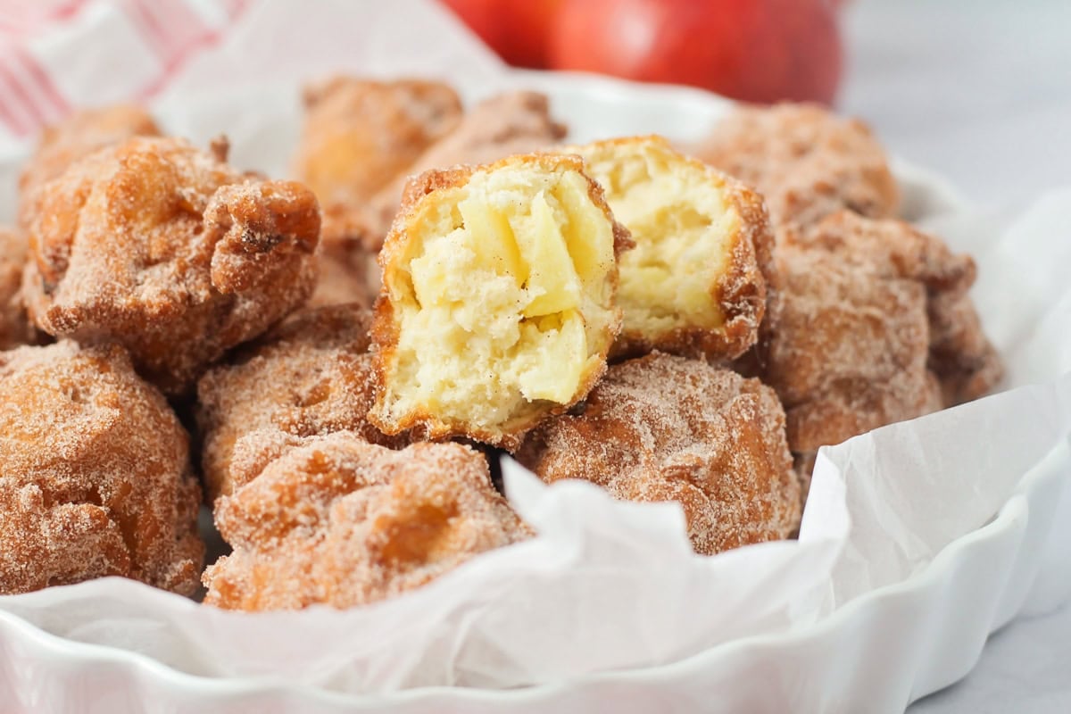 A white bowl of apple fritters.