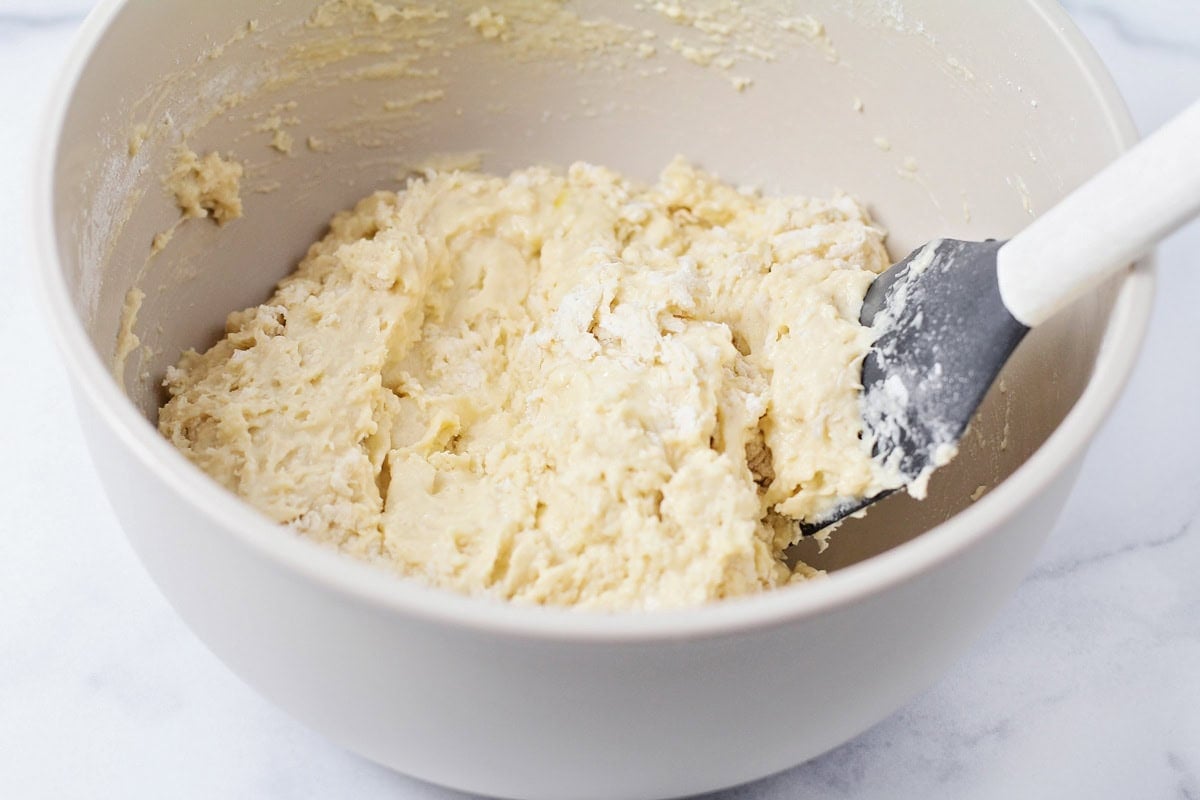 Fritter batter in a white bowl.