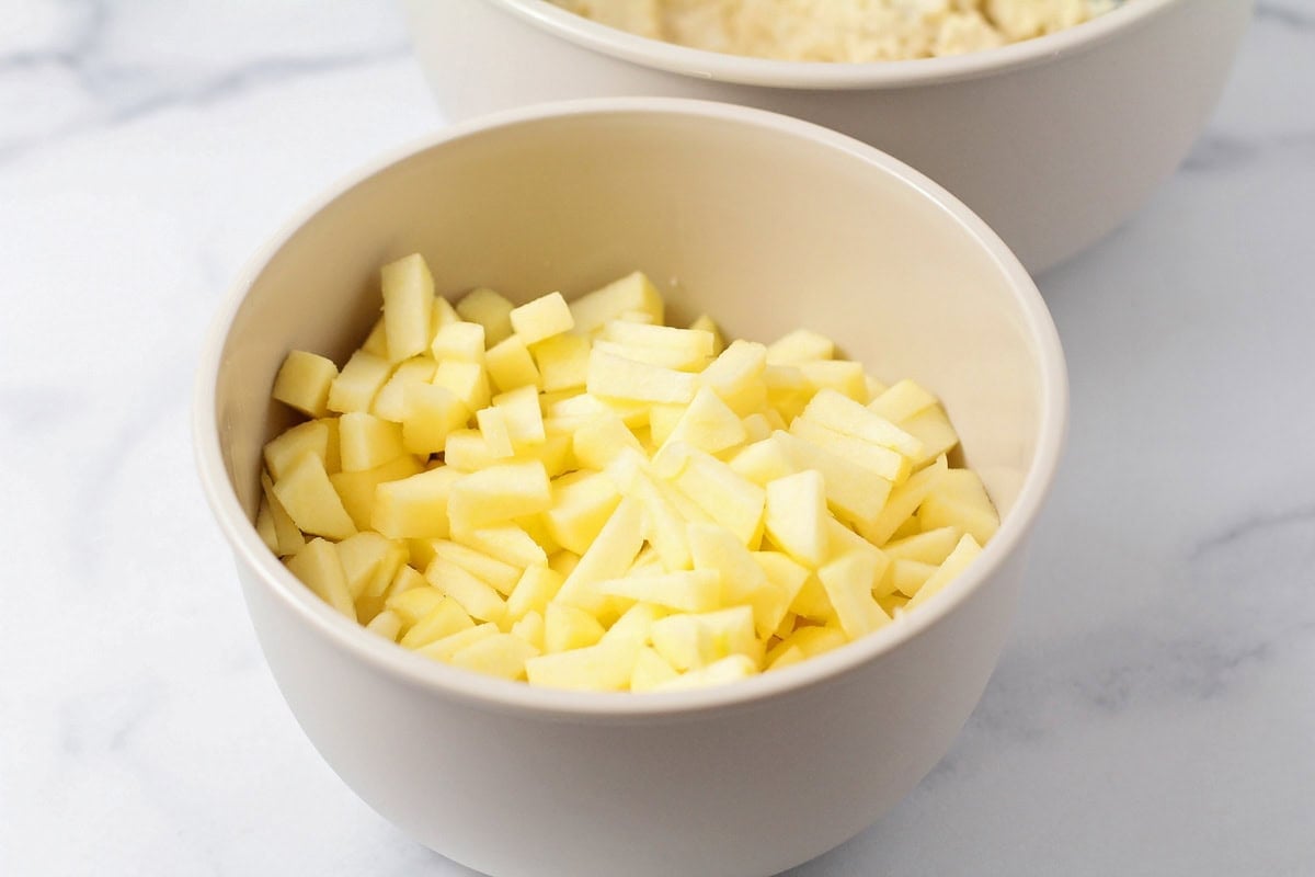 A bowl of diced apples on a counter.