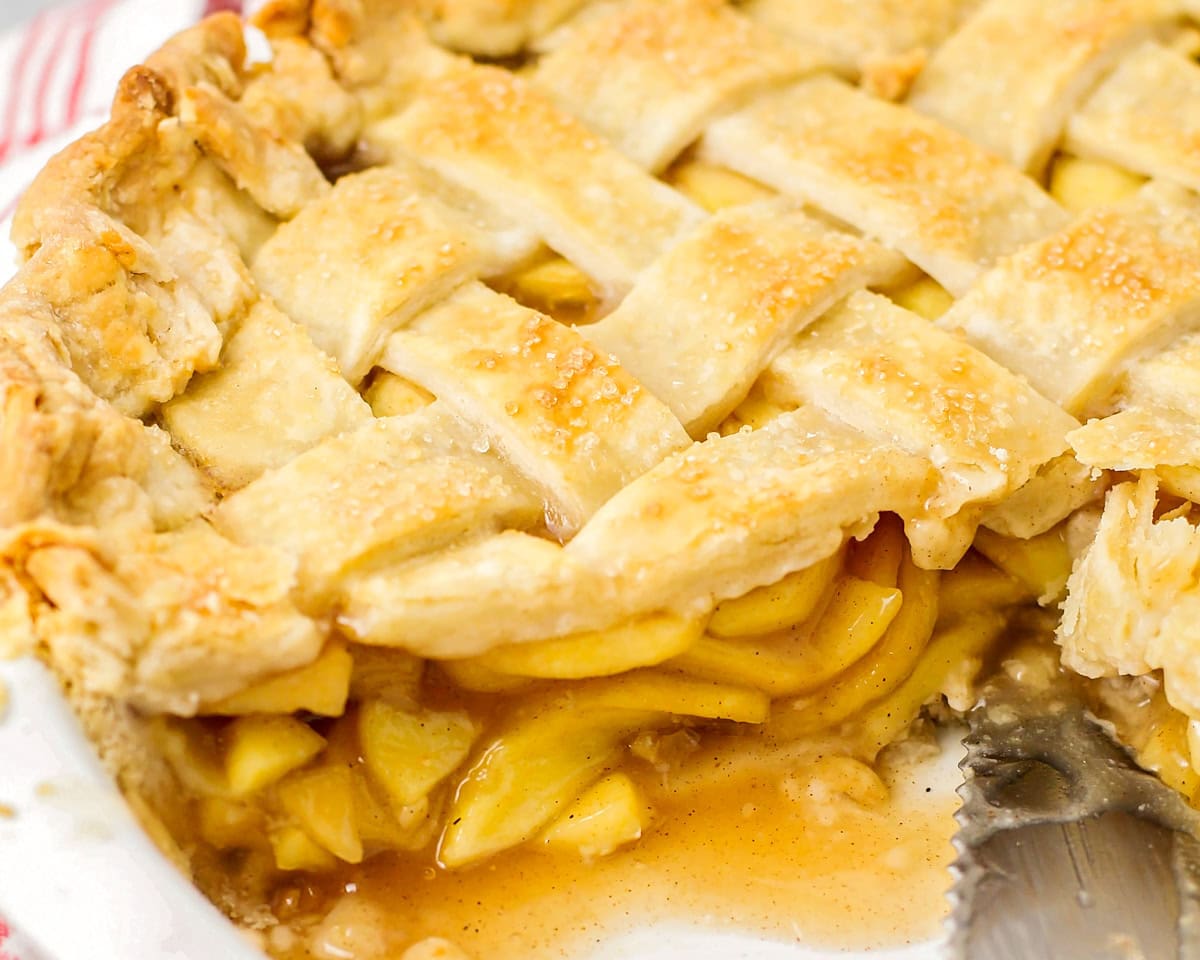 Close up of apple pie filling in an apple pie.