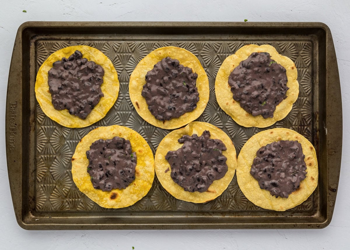 Tostadas topped with black beans.