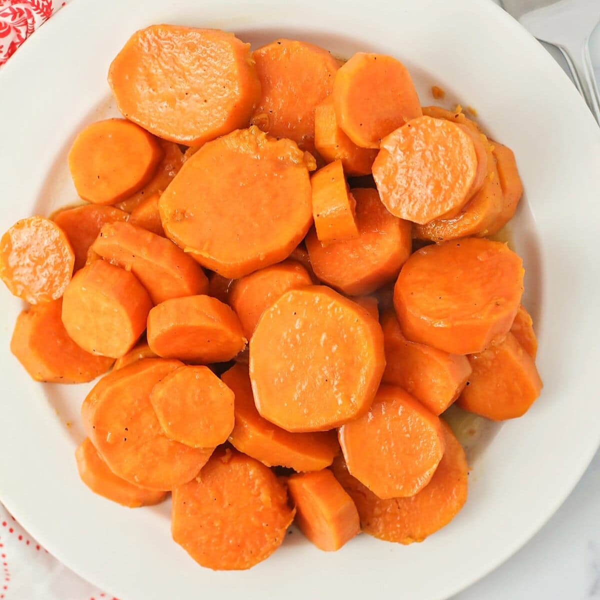 A white bowl of candied yams.