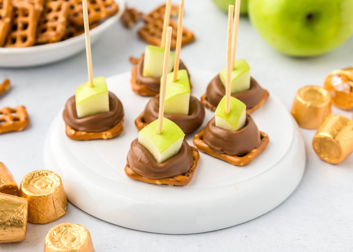 Close up of caramel apple bites served on a small tray.