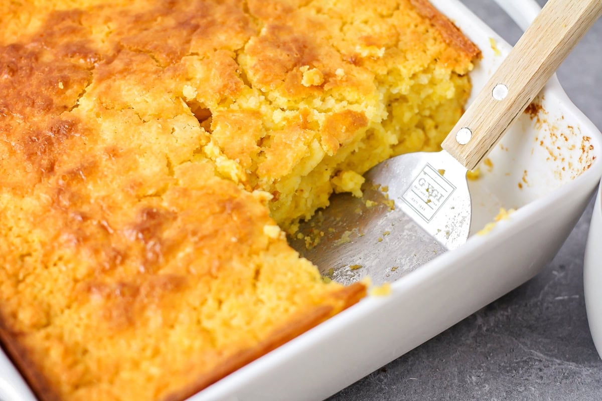 Spatula in baking dish for cornbread casserole.