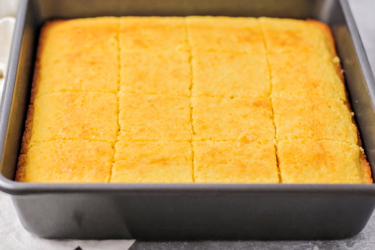 Homemade cornbread cut up in baking dish.