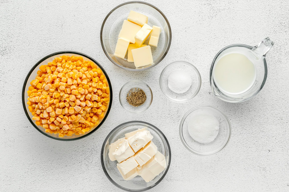 Ingredients for creamed corn in bowls and measuring cups.