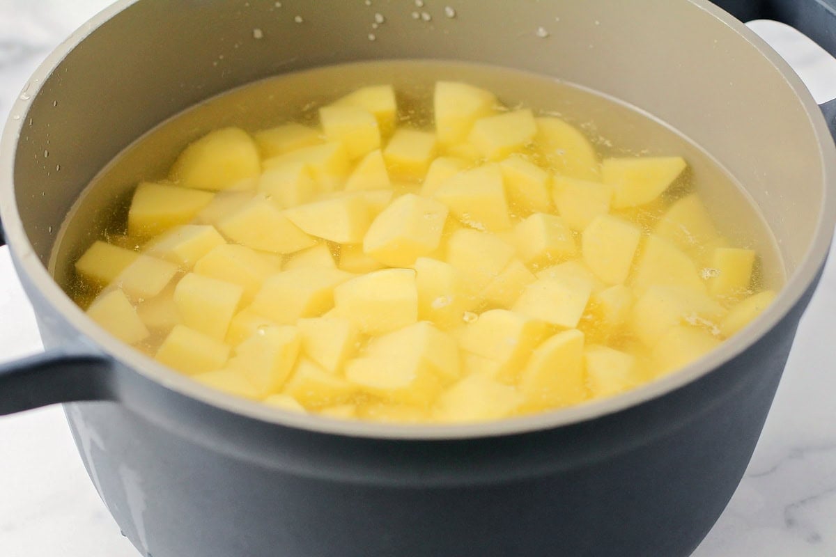 Cubed potatoes in a pot of water.