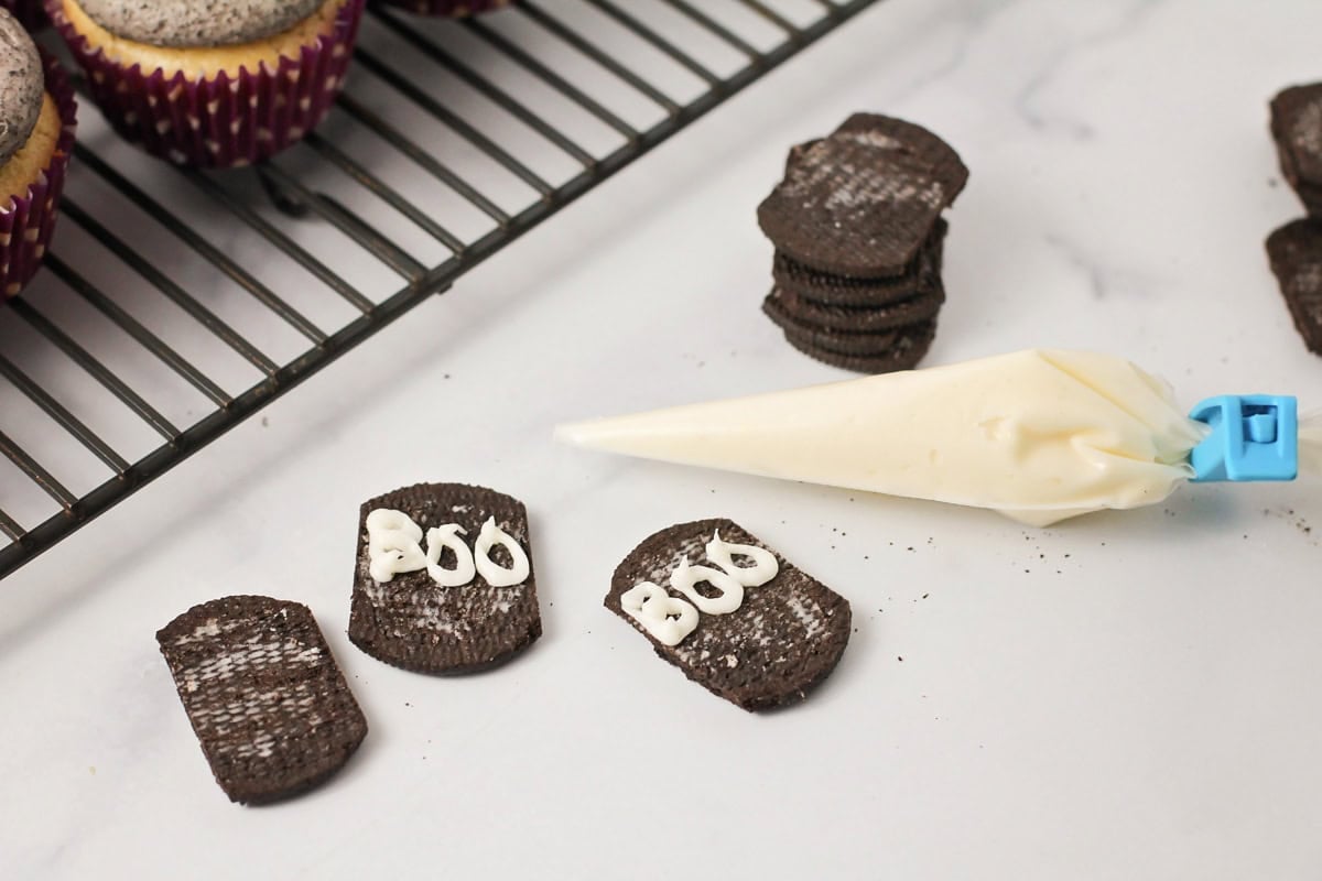 Frosting boo on Oreo gravestones.