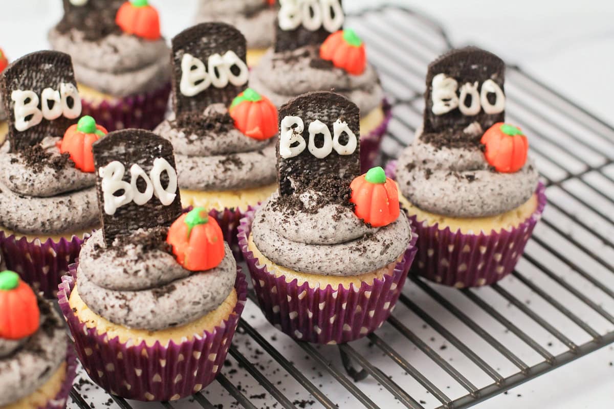 Decorated Halloween cupcakes on a cooling rack.