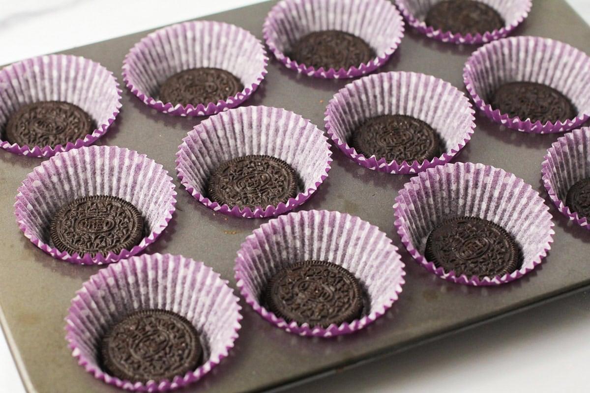 Oreo in the bottom of cupcake liners.